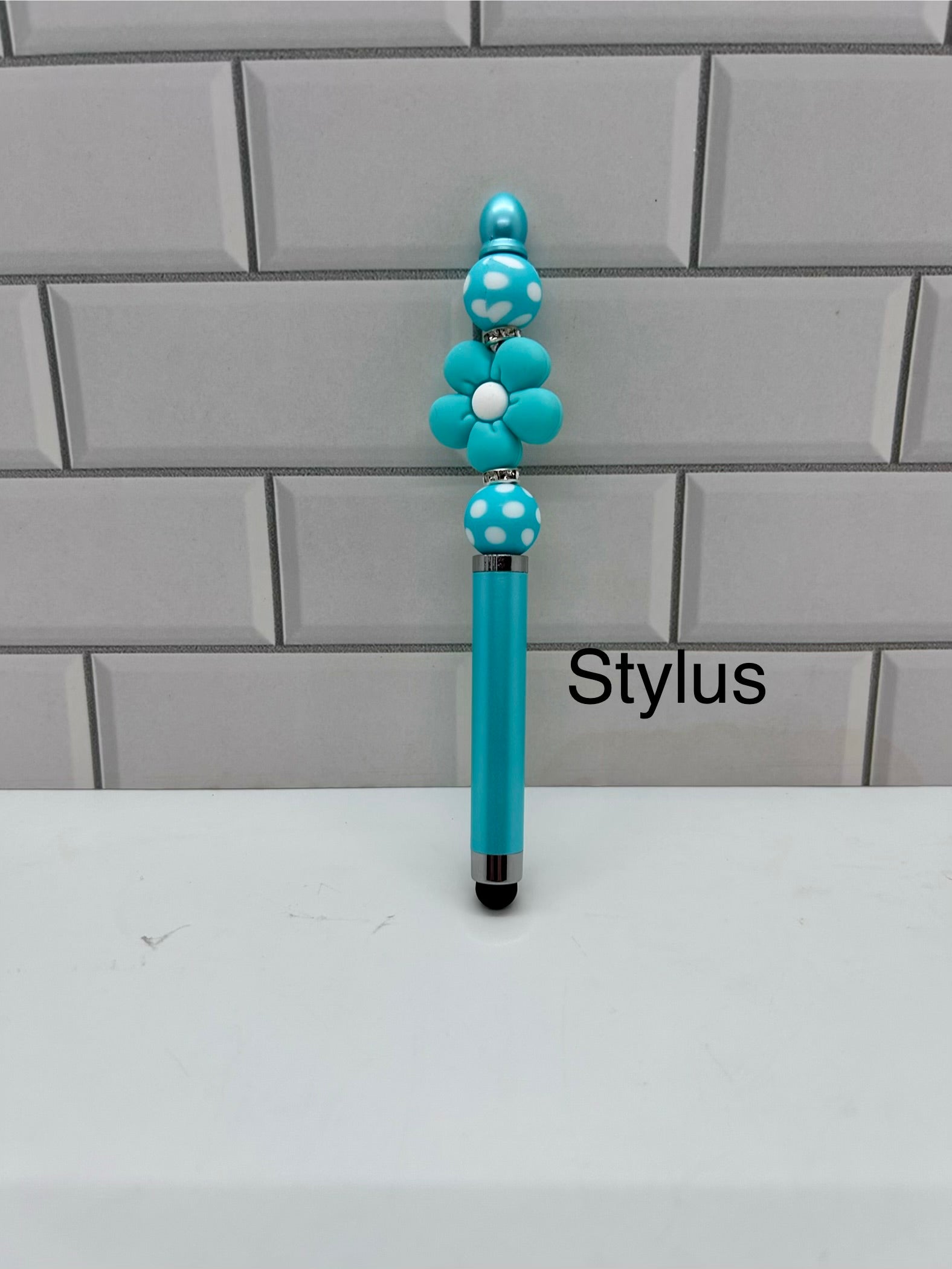 Stylet perlé - Silicone turquoise avec perle florale