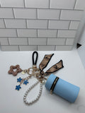 Black Wristlet Keychain Bundles-Blue Cylindrical Bag, Blue Charms, Champagne Star Charm