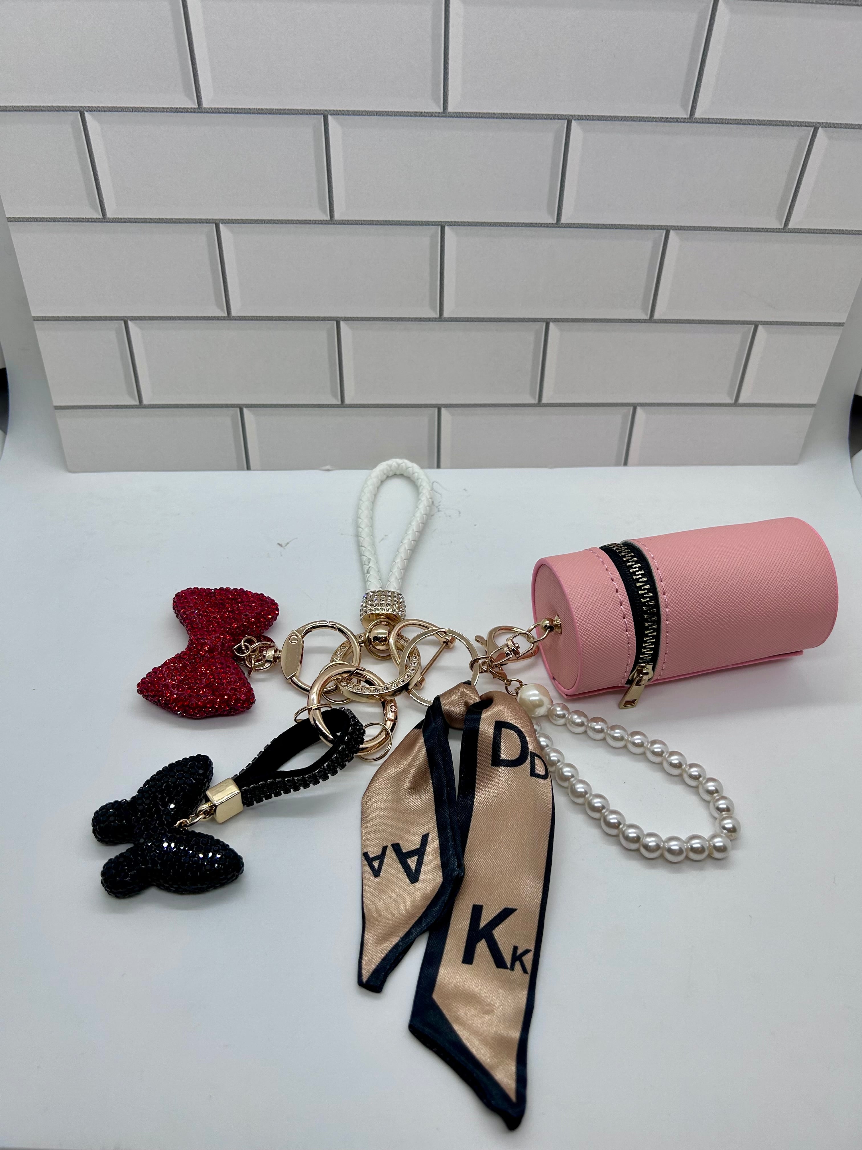 White Wristlet Keychain Bundles-Orange Cylindrical Bag, Red Bow Charm, Black Butterfly Charm
